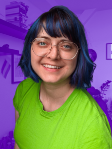 Fanny mit blauen Haaren und grünem Shirt vor ihrer lila eingefärbten Wohnung